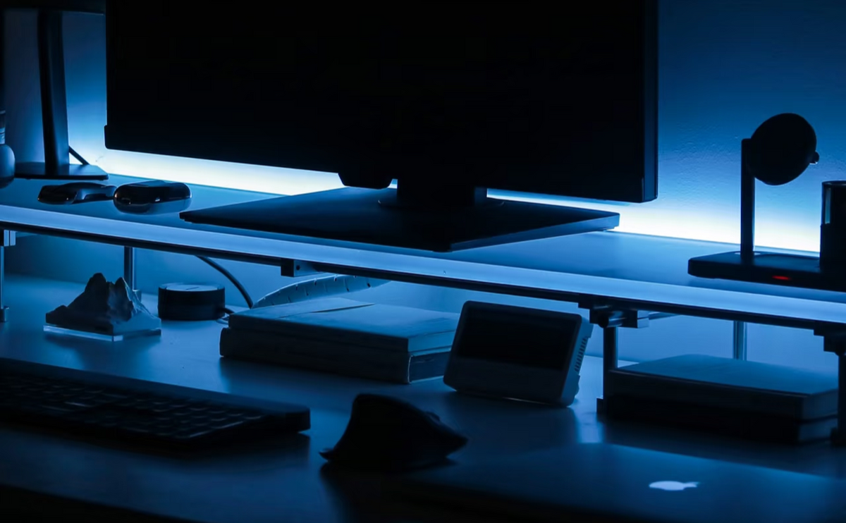 Acrylic monitor riser creates blue night desk ambiance - HushLume