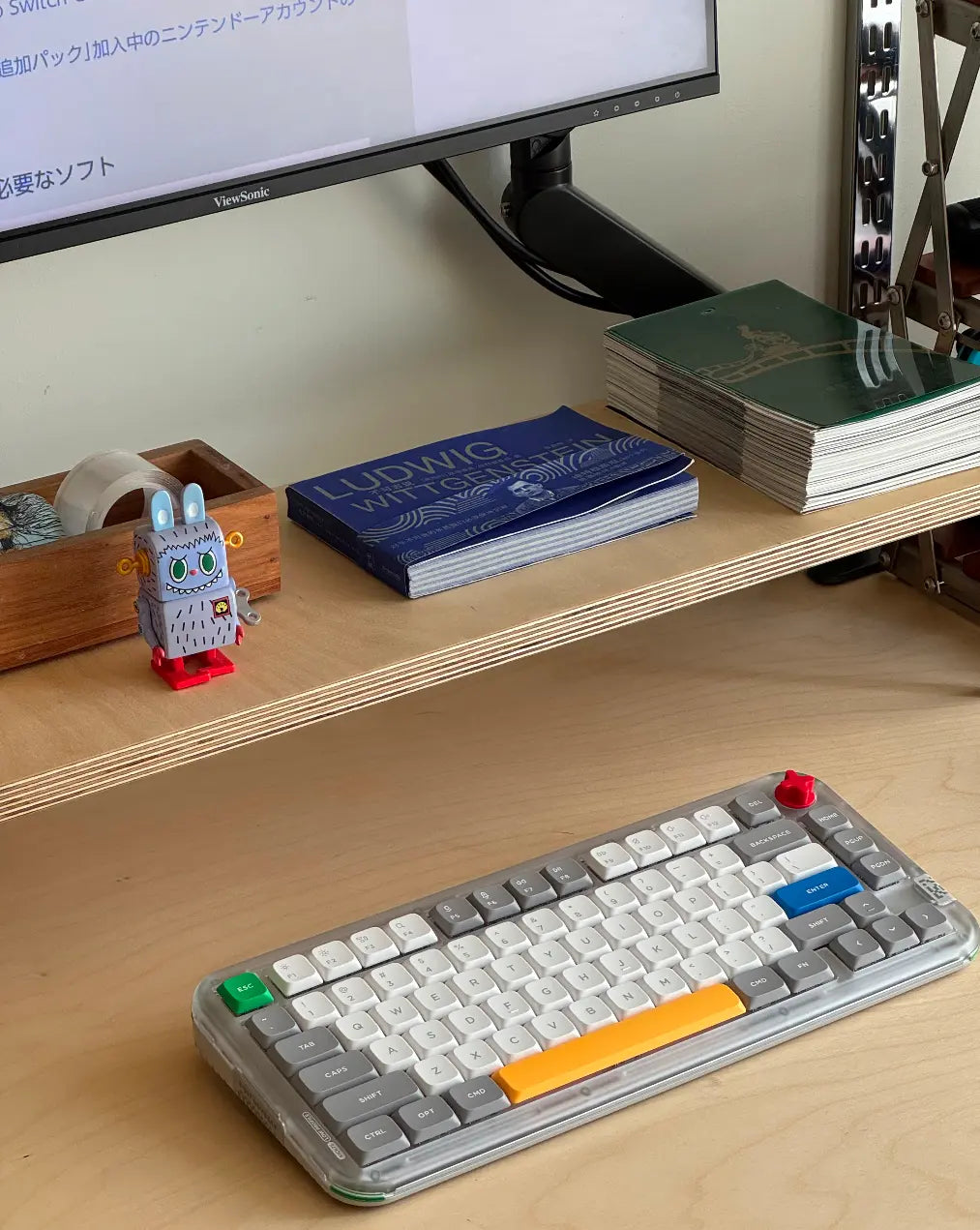 HushLume 18mm marine board display shelf used as monitor riser with ViewSonic monitor, mechanical keyboard, robot figurine and Wittgenstein book on natural birch plywood desk