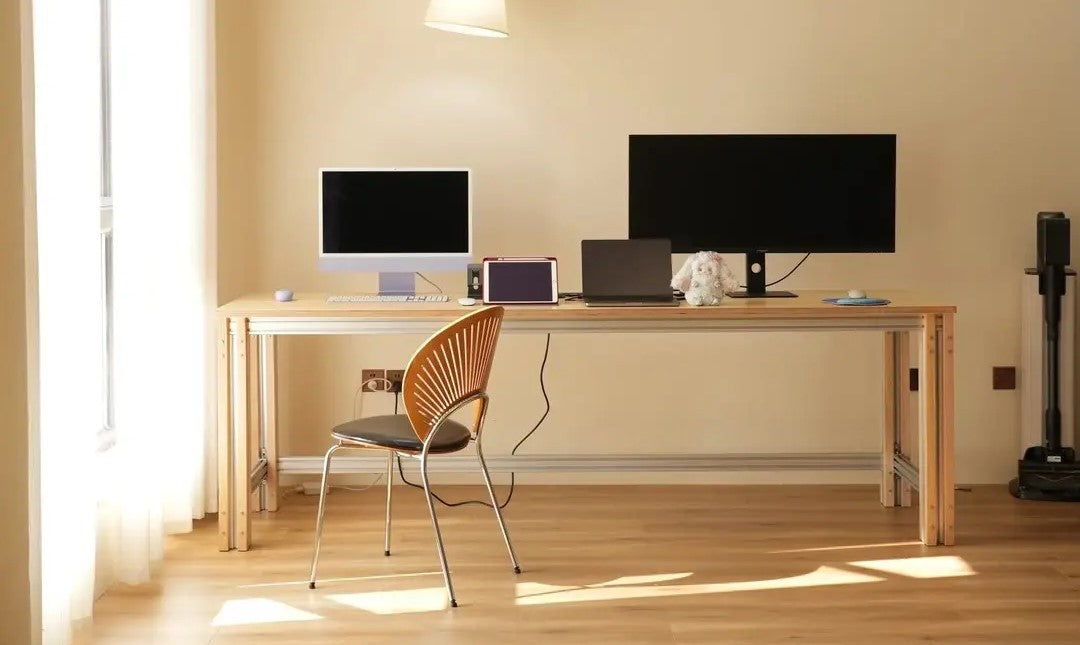 Custom aluminum extrusion desk frame with custom tabletop in a home office workspace