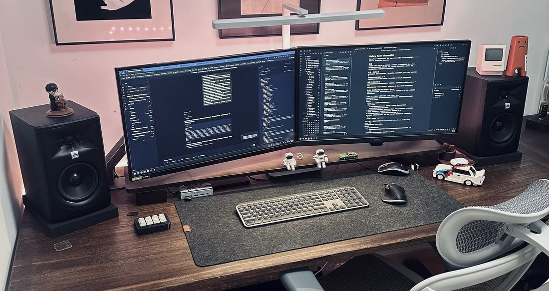Single and dual monitor setup on custom chrome steel acrylic risers showing correct width sizing for different monitor sizes