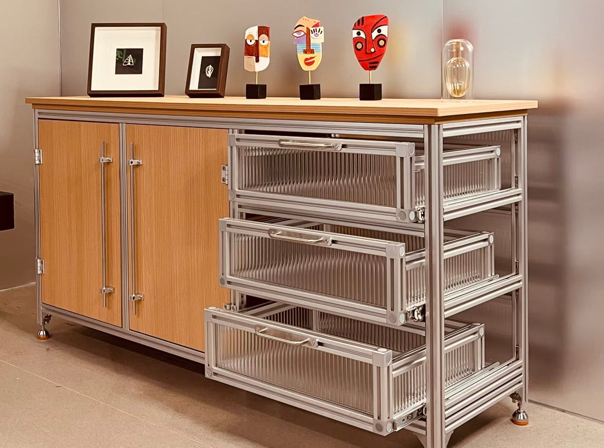 Custom modular aluminum-profile furniture with a rolling three-tier storage cart beside a wooden cabinet.
