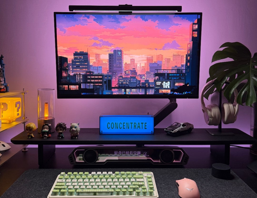 Chrome steel and acrylic monitor riser on a minimal desk setup compared to a monitor arm configuration for home office