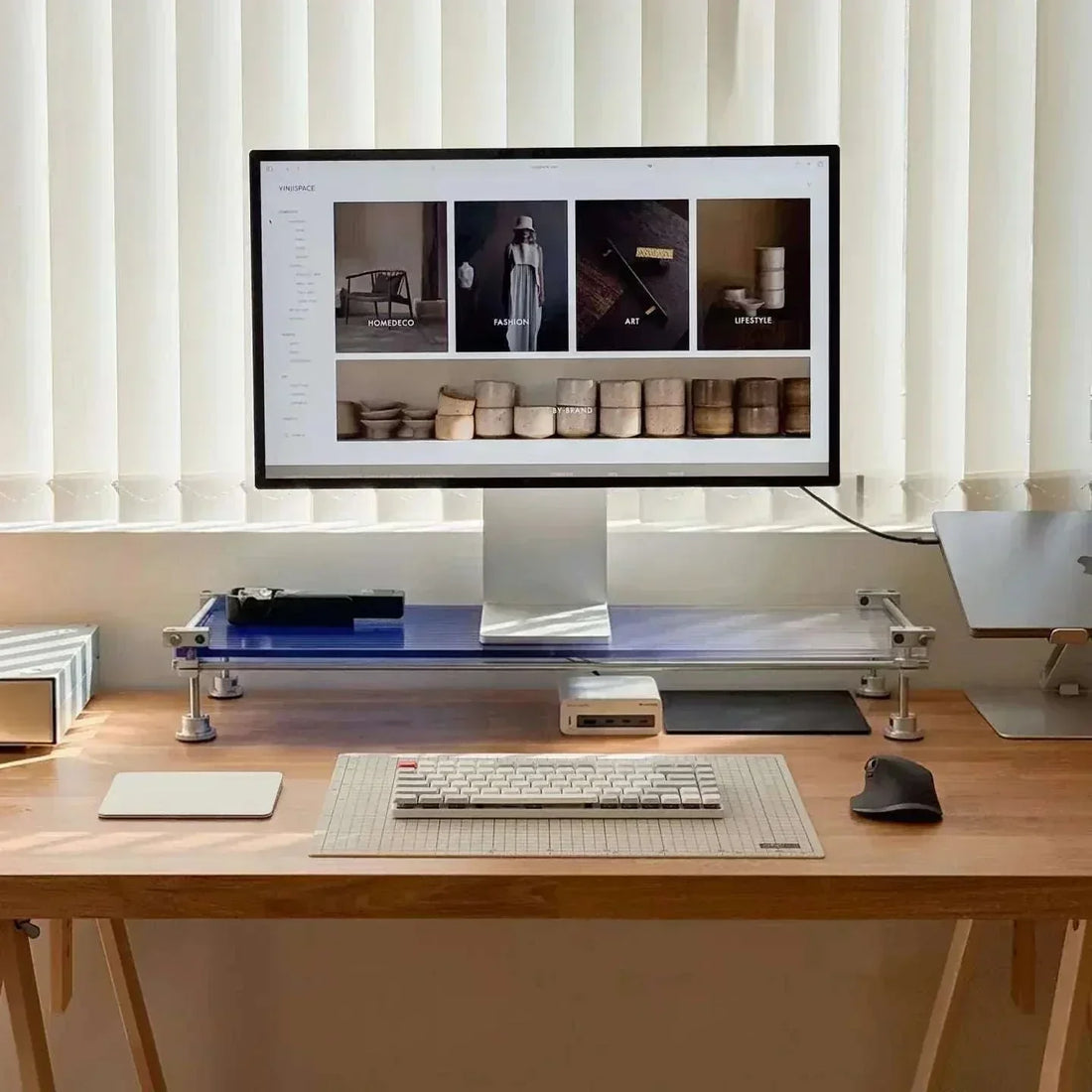 Acrylic monitor riser by HushLume on wooden desk with industrial setup
