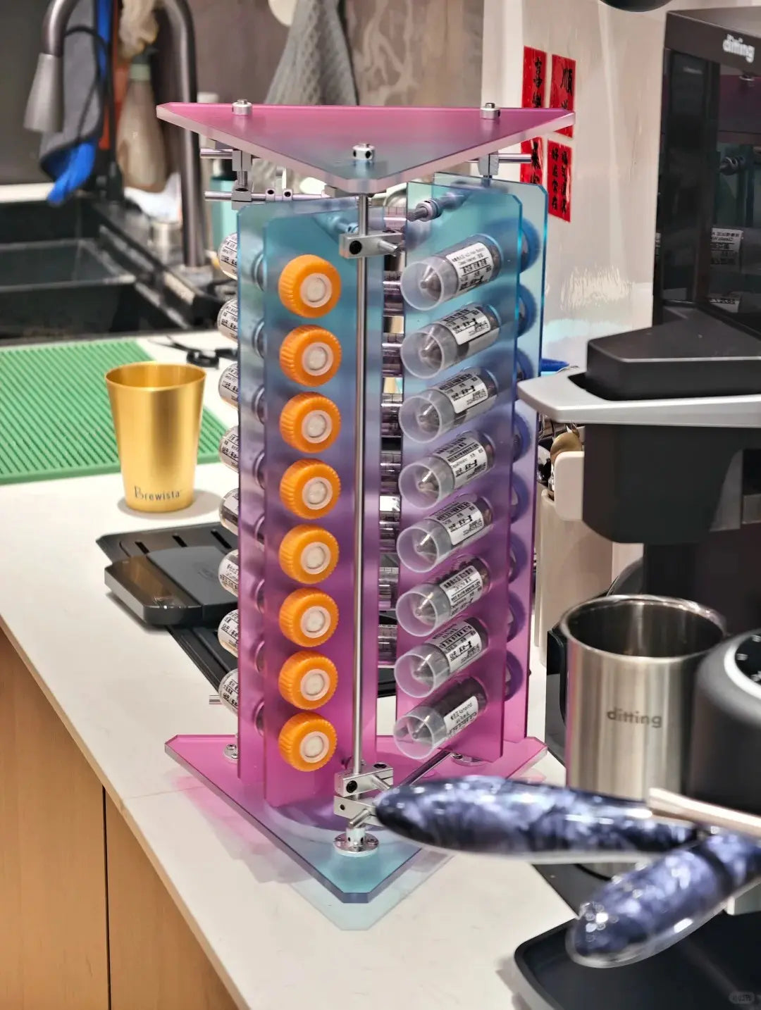HushLume coffee bean display stand front view — chrome steel shafts and 50ml degassing valve tubes