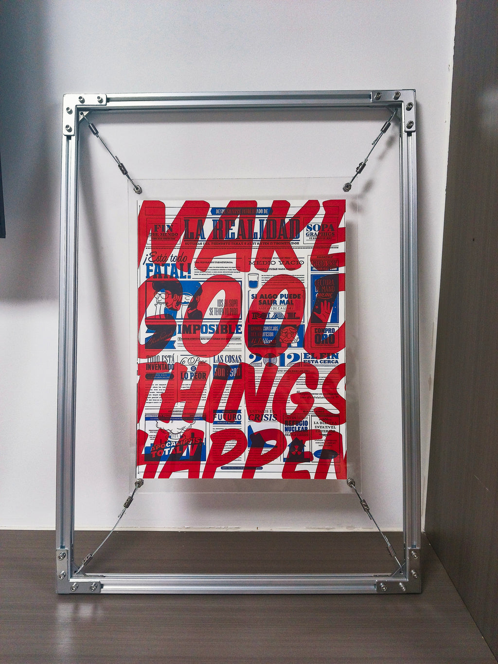 Front view of HushLume 2020 aluminum floating frame, detailing the steel wire suspension turnbuckle mechanism with a bold red graphic art print.